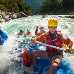 Rafters get splashed as they go through some big rapids on the Karnali river in Nepal